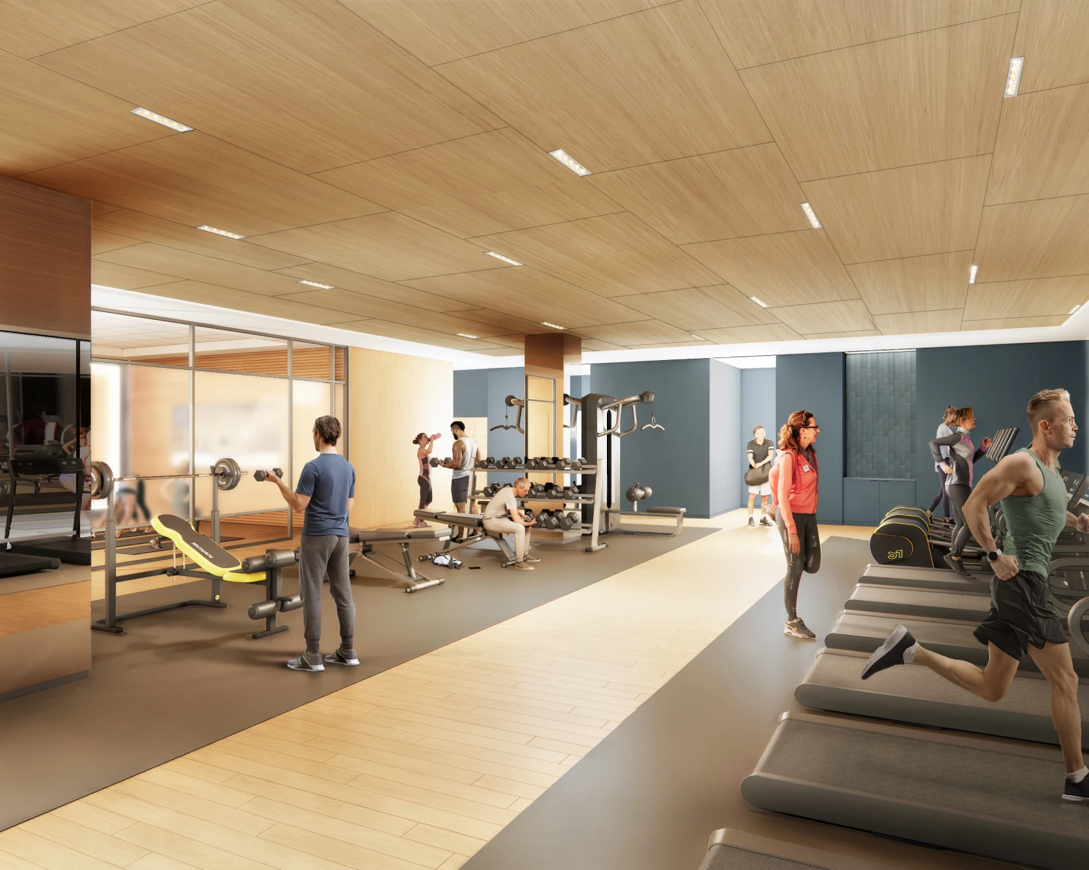 Spacious corporate gym with mirrored walls, free weights, and group workouts in progress